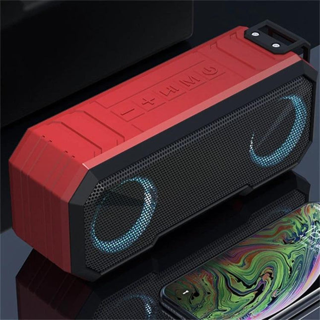 Waterproof Portable Bluetooth Speaker For Beach Camping And Backyard red rugged IPX7 speaker with LED rings near smartphone