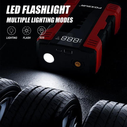 FOXSUR Portable Emergency Car Starter with Air Pump shown with LED flashlight illuminating car tires, multiple lighting modes and digital display