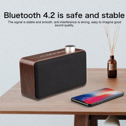 Compact Bluetooth Speaker For Home And Travel With Portable Design wooden-look speaker with metal knob phone on table, Bluetooth 4.2