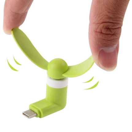 Compact Portable Fan for Smartphone Cooling via USB-C Port shown green USB-C plug fan attached to fingers for size and cooling demo
