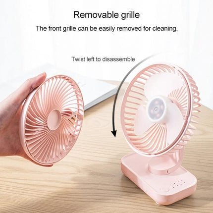 Compact Rechargeable Desktop Fan with Adjustable Speeds for Home and Office showing removable front grille being twisted off for cleaning on a desk