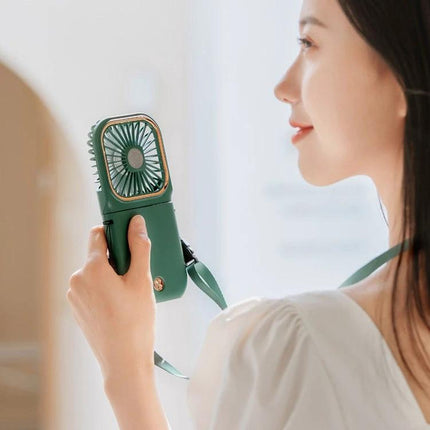 Portable F30 Hanging Neck and Handheld Fan for Daily Cooling held by woman in green, showing handheld and hanging neck use, lightweight and portable