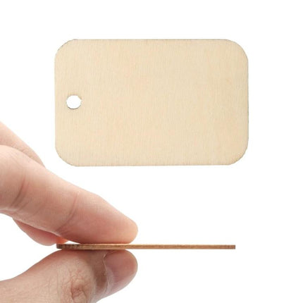 XTOOL 150-Piece Rectangular Poplar Wood Pieces for Crafting showing a small unfinished rectangular poplar tag with hole and thin profile held between fingers