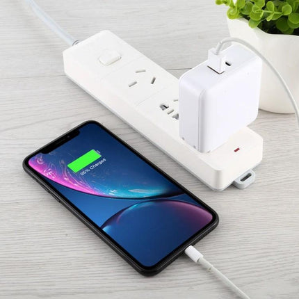 Compact USB Charger for Daily Travel and Home Use charging a smartphone from a compact wall charger plugged into a power strip