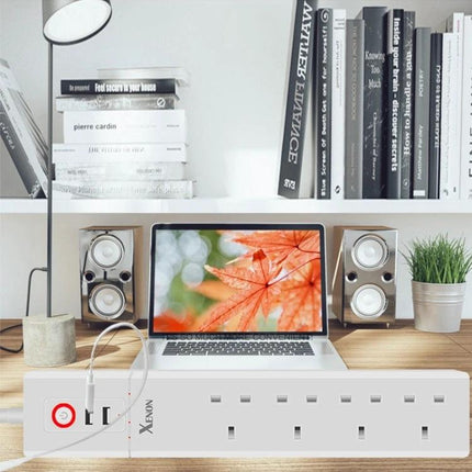 WiFi Smart Power Socket with USB and UK Plugs for Home Automation on desk powering laptop and speakers