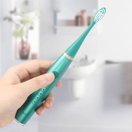 Electric Dental Scaler Replacement Heads White 5 Pack For At Home Cleaning - teal ultrasonic scaler held in hand for at-home plaque and stain removal