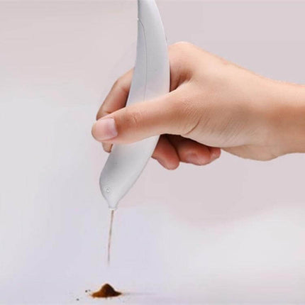 Electric Latte Art Pen for Coffee and Cake Decorating held over coffee grounds demonstrating precise drizzle for latte art and cake decoration