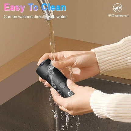 Electric Foot File Pedicure Kit White For Home Foot Care handheld USB rechargeable device being rinsed under tap water, LED display visible, three-speed settings