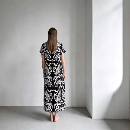 Elegant Loose Fitting Long Dress With Sailor Collar in black-and-white printed knit, back view on a model in minimalist studio