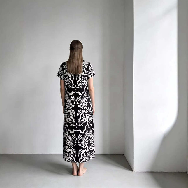 Elegant Loose Fitting Long Dress With Sailor Collar in black-and-white printed knit, back view on a model in minimalist studio