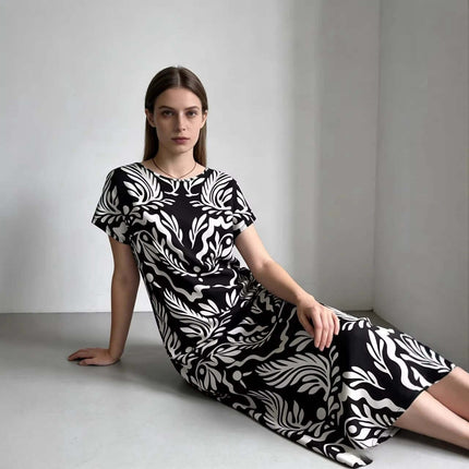 Elegant Loose Fitting Long Dress With Sailor Collar in black white knitted print, model seated showing relaxed drape and vintage-inspired silhouette
