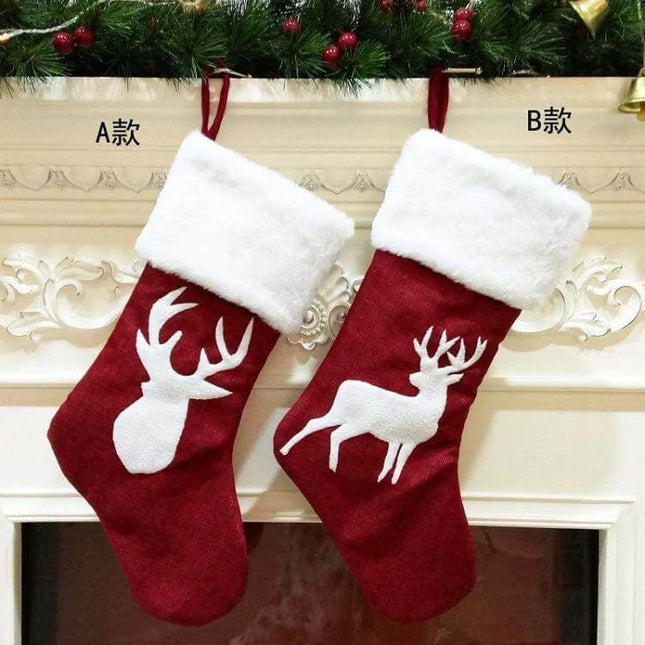 Embroidered Christmas Stocking Ornament Gift Bag Snowflake Style red linen stocking with white faux-fur cuff and reindeer motif hanging on mantle