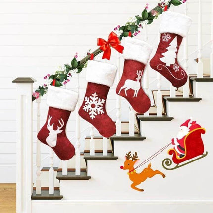 Embroidered Christmas Stocking Ornament Gift Bag Snowflake Style hanging on staircase with reindeer, snowflake, tree motifs and Santa sleigh decor