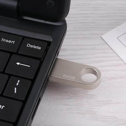 64GB Metal USB Flash Drive for Everyday Data Storage - metal 64GB USB stick plugged into laptop for photo, video and document transfers