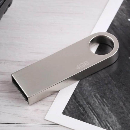 Compact 4GB Metal USB Flash Drive for Storing Files and Photos shown on desk with durable metal body