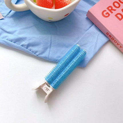 Fluffy Hair Clips For Volumizing Roots blue dual-roller clip with long teeth on tabletop for root lift and natural volume