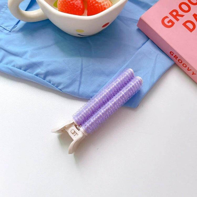 Fluffy Hair Clips For Volumizing Roots purple double-roller clip shown on blue cloth near mug and book, lifts roots for natural volume