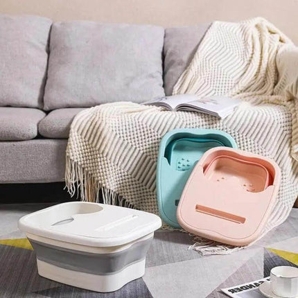 Foldable Foot Bath Bucket 15L For Easy Home Soak And Massage in pastel pink and teal folded and set beside sofa, 15L collapsible foot spa with acupressure nodules