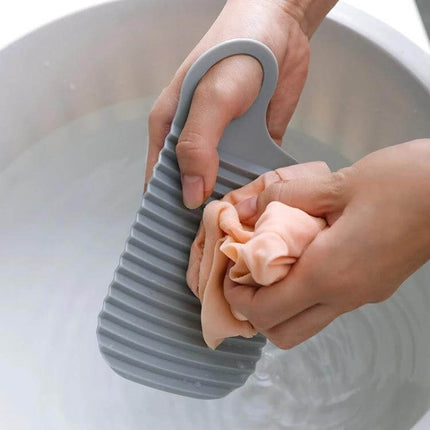 Foldable Soft Silicone Laundry Board White For Home Use - hand using compact foldable silicone scrub board to gently wash delicates and collars