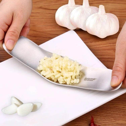 Garlic Press Stainless Steel For Everyday Garlic Crushing - 304 stainless ergonomic garlic rocker crushing garlic into paste on plate