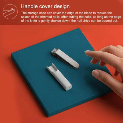 Xiaomi Mijia Splash Proof Nail Clippers With Anti Splash Case on teal pad showing clipper and white anti-splash cover