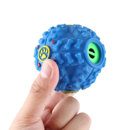 Chew Ball Toy for Everyday Pet Play and Training Fun - blue textured chew ball with footprint and bone patterns held between fingers, treat-dispensing opening