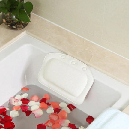 Plush Bathtub Headrest for Relaxing Evening Baths at Home - white PVC foam headrest on tub with rose petals for a soothing soak