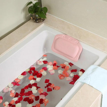 Plush Bathtub Headrest for Relaxing Evening Baths at Home - pink PVC foam headrest in a rose-petal filled tub for comfortable evening soak