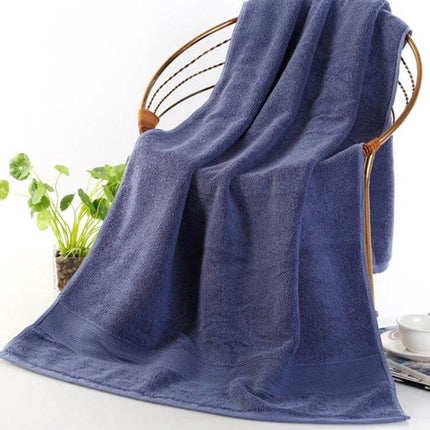 Bath Towel 70x140 cm For Everyday Home Use And Comfort soft 100% cotton plush navy towel draped on chair, high absorbency 650g