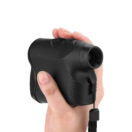 Golf Laser Range Finder 5-600m For Distance To Flag Or Green handheld black unit in golfer’s hand showing lens and wrist strap