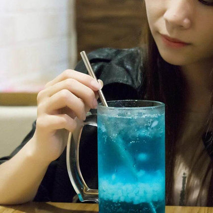 Reusable Stainless Steel Drinking Straw With Brush, 4-Pack, 215x6mm — person using stainless steel straw in blue drink, includes cleaning brush set
