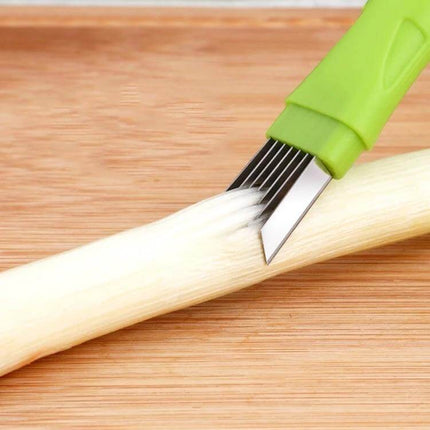 Manual Green Onion Slicer With Stainless Steel Blade For Quick Prep cutting scallions on a wooden board with protective cover and green polypropylene handle