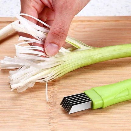 Manual Green Onion Slicer With Stainless Steel Blade For Quick Prep cutting scallions on a board with protective cover and even stainless blades