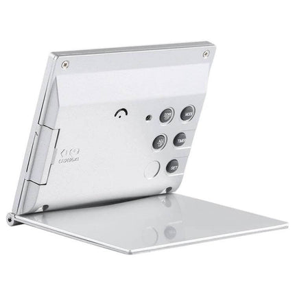 Portable Folding LCD Travel Alarm Clock With Temperature Display showing compact foldable silver design with buttons and stand