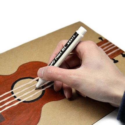 Hand using Conductive Ink Pen for Drawing and Creating Electronic Circuits to draw circuit-like lines on paper ukulele artwork for prototyping and learning