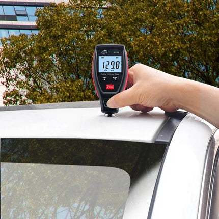 Benetech Dual-Purpose Coating Thickness Gauge for Metals measuring car roof paint thickness, handheld gauge display reading 129.8 µm