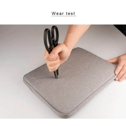 Alt Tag: Oxford Cloth Protective Bag for Laptops Up to 15.6 Inches, Various Colors - gray sleeve showing scissors wear test demonstrating scratch resistance