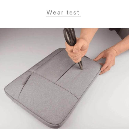 Protective Laptop Sleeve for 15.6-Inch Laptops and Smaller showing scissors wear test on grey sleeve to demonstrate scratch and puncture resistance