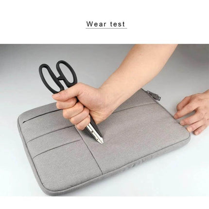 Laptop Sleeve for Up to 15.6 Inch Devices with Storage Pockets showing wear test with scissors demonstrating durable, water-resistant fabric and protective padding