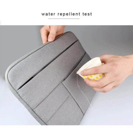 Laptop Sleeve for Up to 15.6 Inch Devices with Storage Pockets showing water-repellent surface during spill test, gray sleeve with pockets