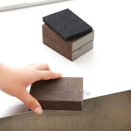 Kitchen Emery Pot Cleaner Sponge For Rust Stain Removal 10x7x2.5cm - hand holding emery sponge cleaning surface