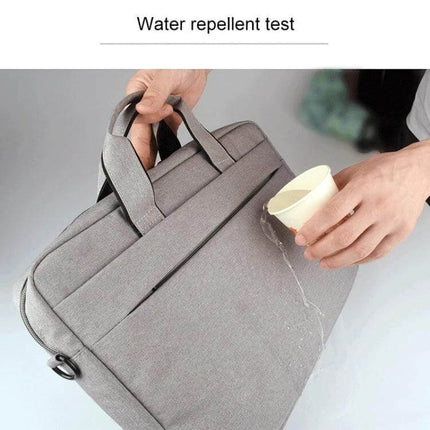 Versatile Protective Laptop Bag for 14-Inch Devices being water-repellent; gray bag with water poured on its waterproof polyester surface