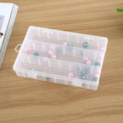 Plastic Removable Grid Organizer For Jewelry 24 Slot - clear plastic 24-slot removable grid tray holding beads and small jewelry on wooden desk