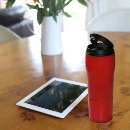 Mighty Mug Solo Travel Mug 500ml For Coffee, Tea, On The Go red travel mug on table with tablet and vase