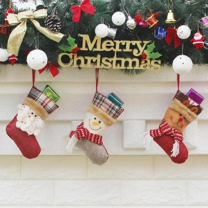 Hang Ornament Christmas Stockings Gift Bags For Decorating hung on mantel with Santa snowman reindeer designs and small wrapped gifts