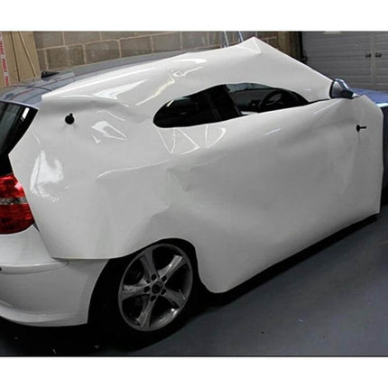 Black Vehicle Magnet Holder for Graphic Sign Application holding vinyl wrap steady on white hatchback during vehicle graphics installation