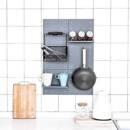 A Versatile Wall Shelf for Home Storage and Organization mounted in a kitchen holding spices, cups, utensils and a frying pan