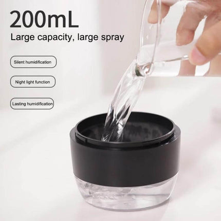 Devil Atomizing Humidifier With Colorful Night Lights being filled into its 200 mL tank, compact portable design for desk or travel