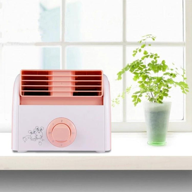 Bladeless Mini Desktop Fan for Quiet Everyday Cooling in Homes on a desk near a window with a plant, compact pink-and-white design