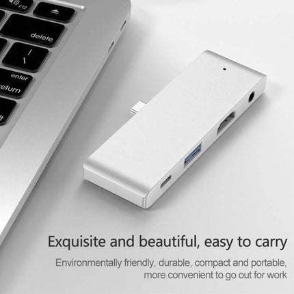 Versatile USB-C Hub for iPad Pro Connectivity Expansion — silver hub showing USB 3.0, USB-C PD port and headphone jack next to laptop